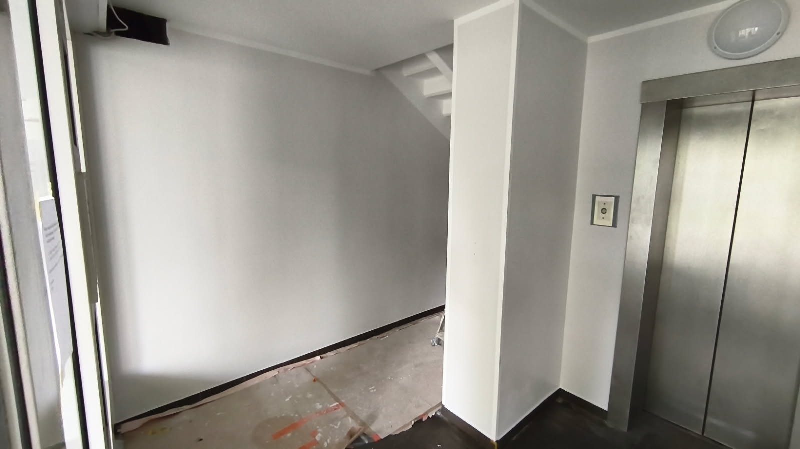 Entrance lobby after wall and ceiling refresh.