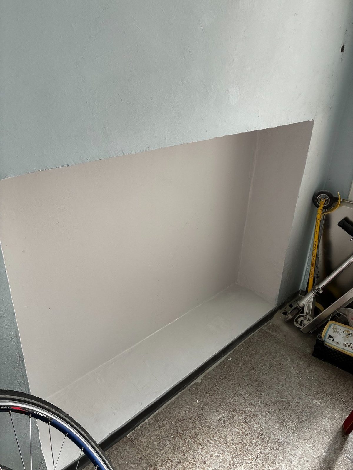 Completed radiator recess repair with smooth painted finish.