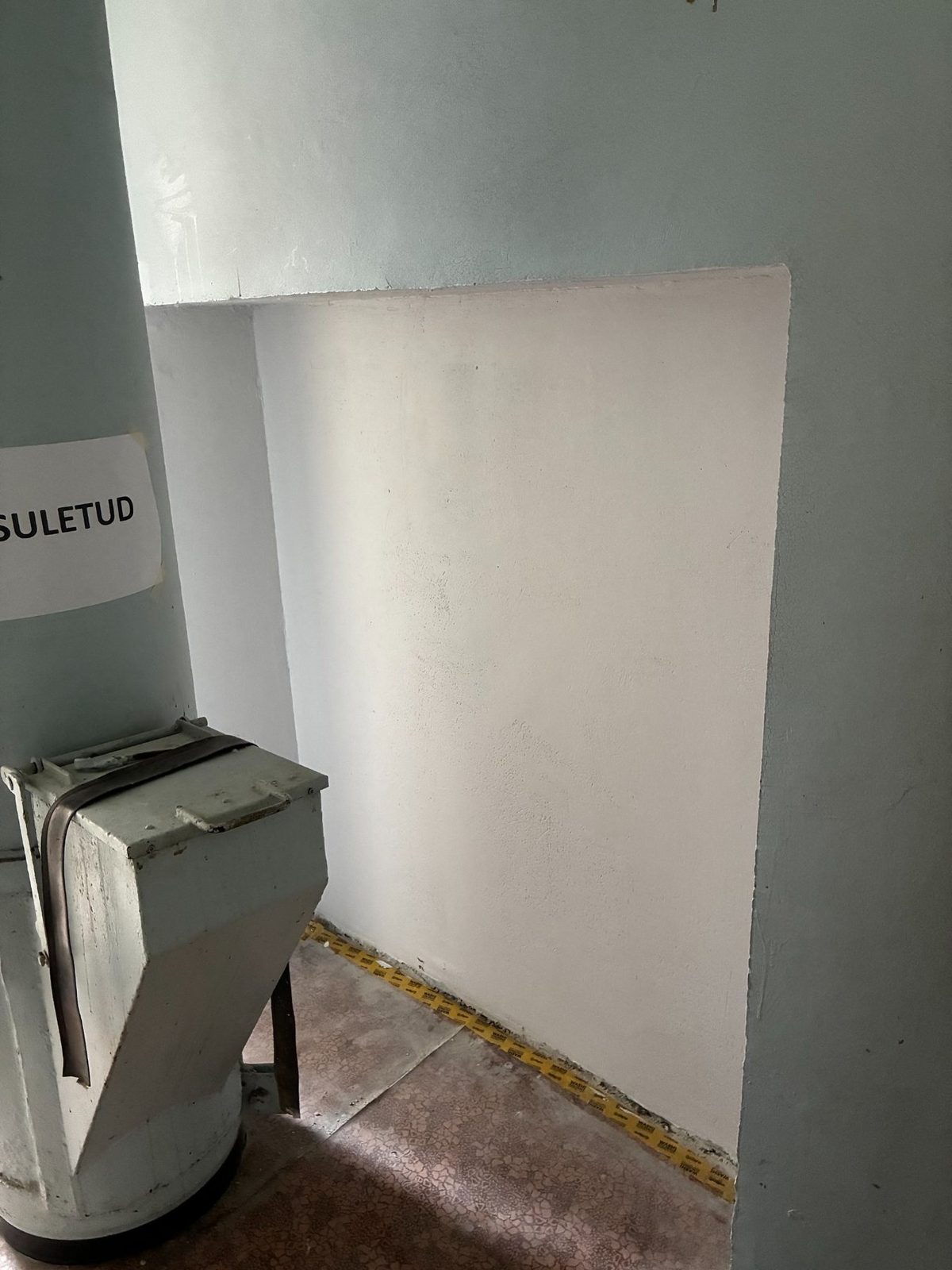 Uniform white finish after wall preparation and painting.