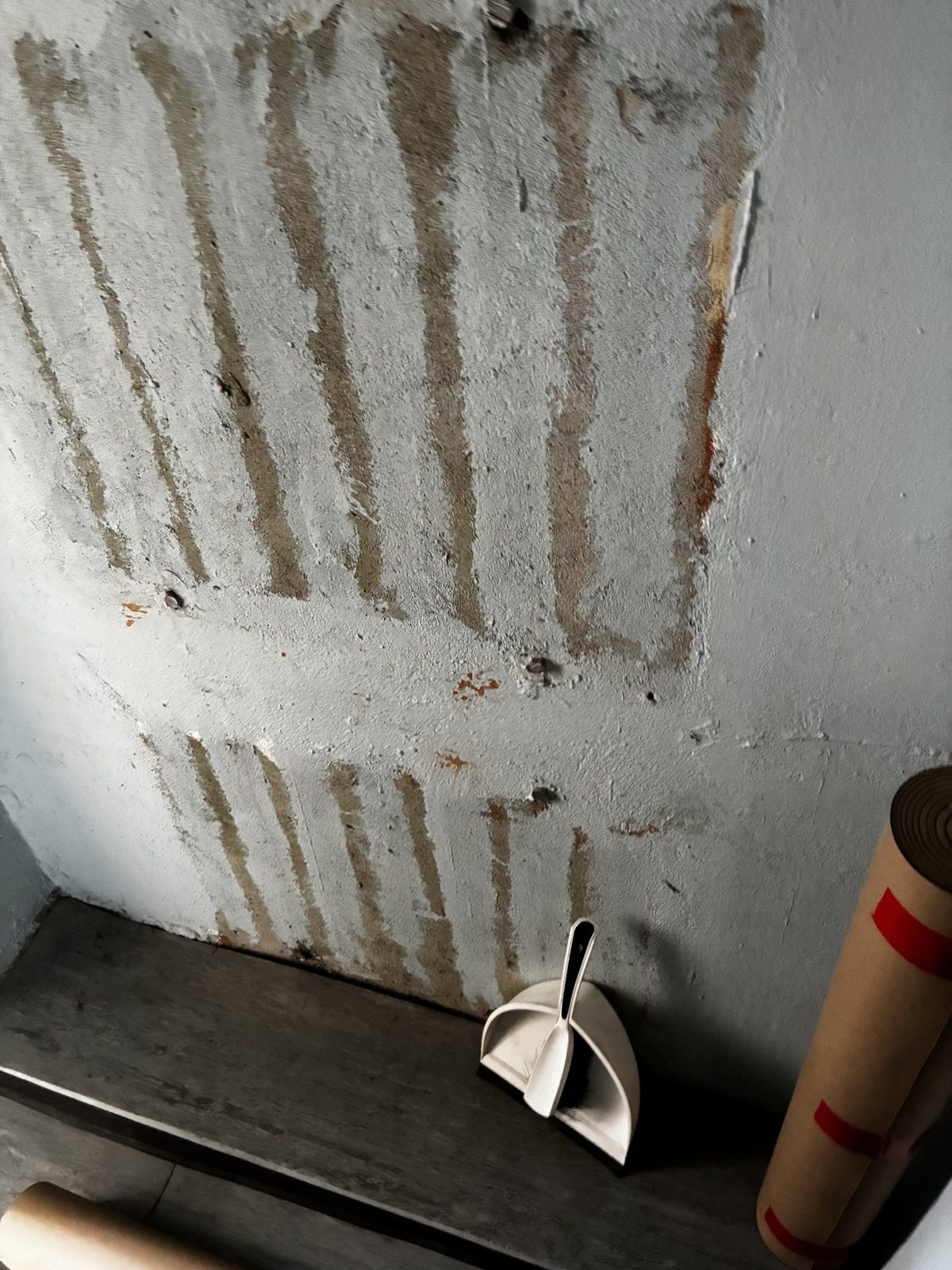 Damaged wall surface after radiator removal.