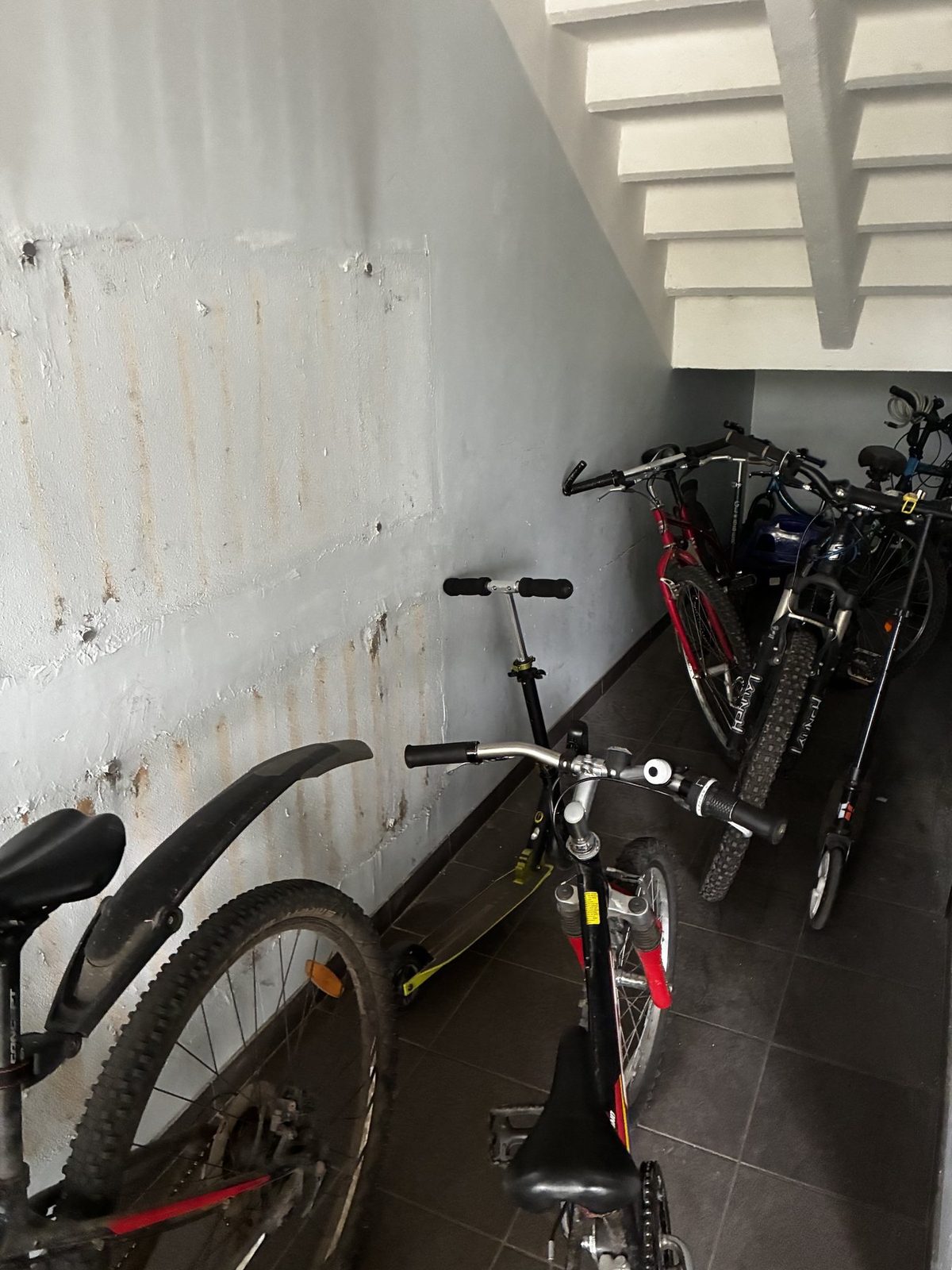 Storage area with worn wall surfaces before restoration.