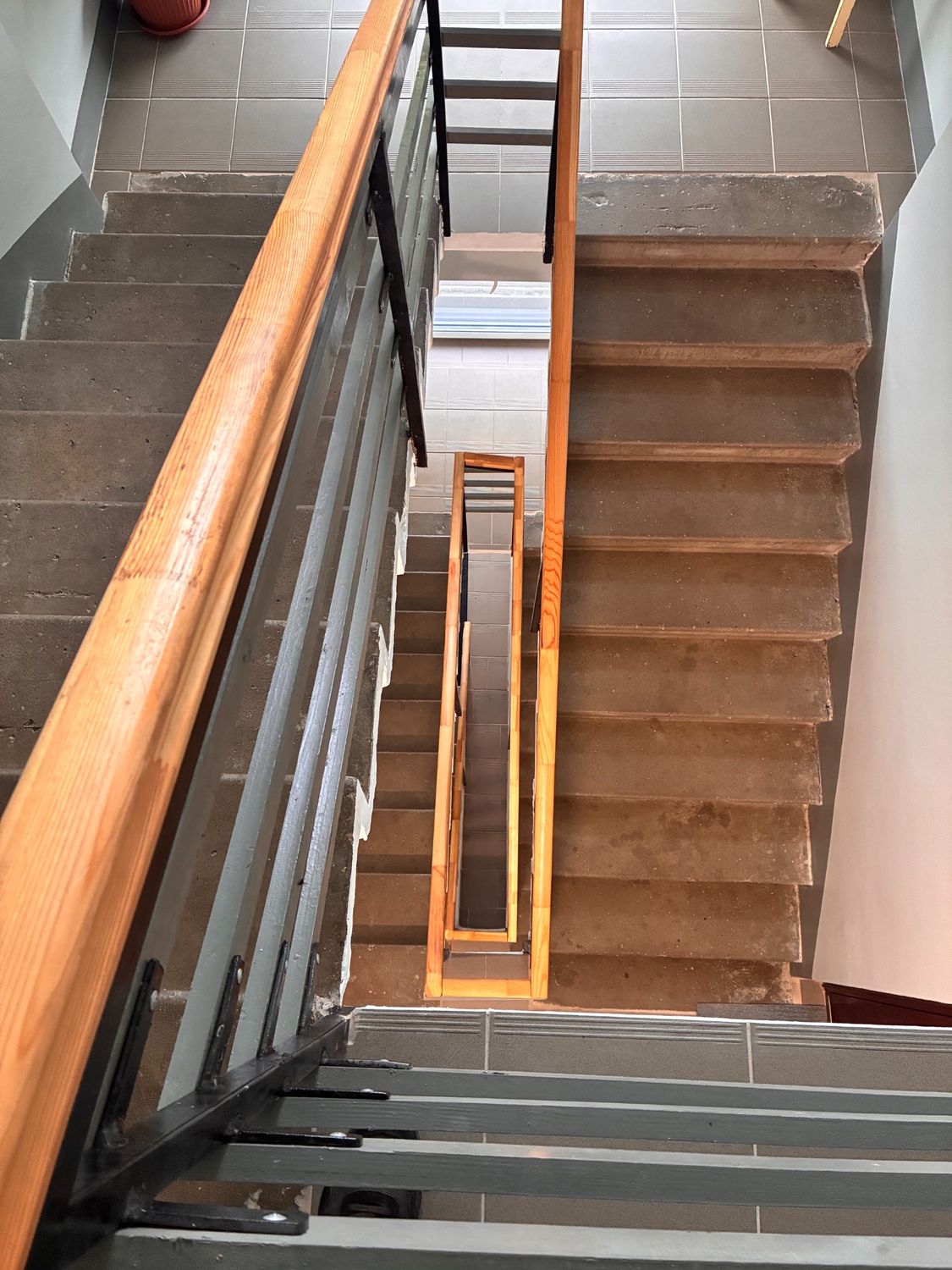 Renewed handrails and tiled stair landings.