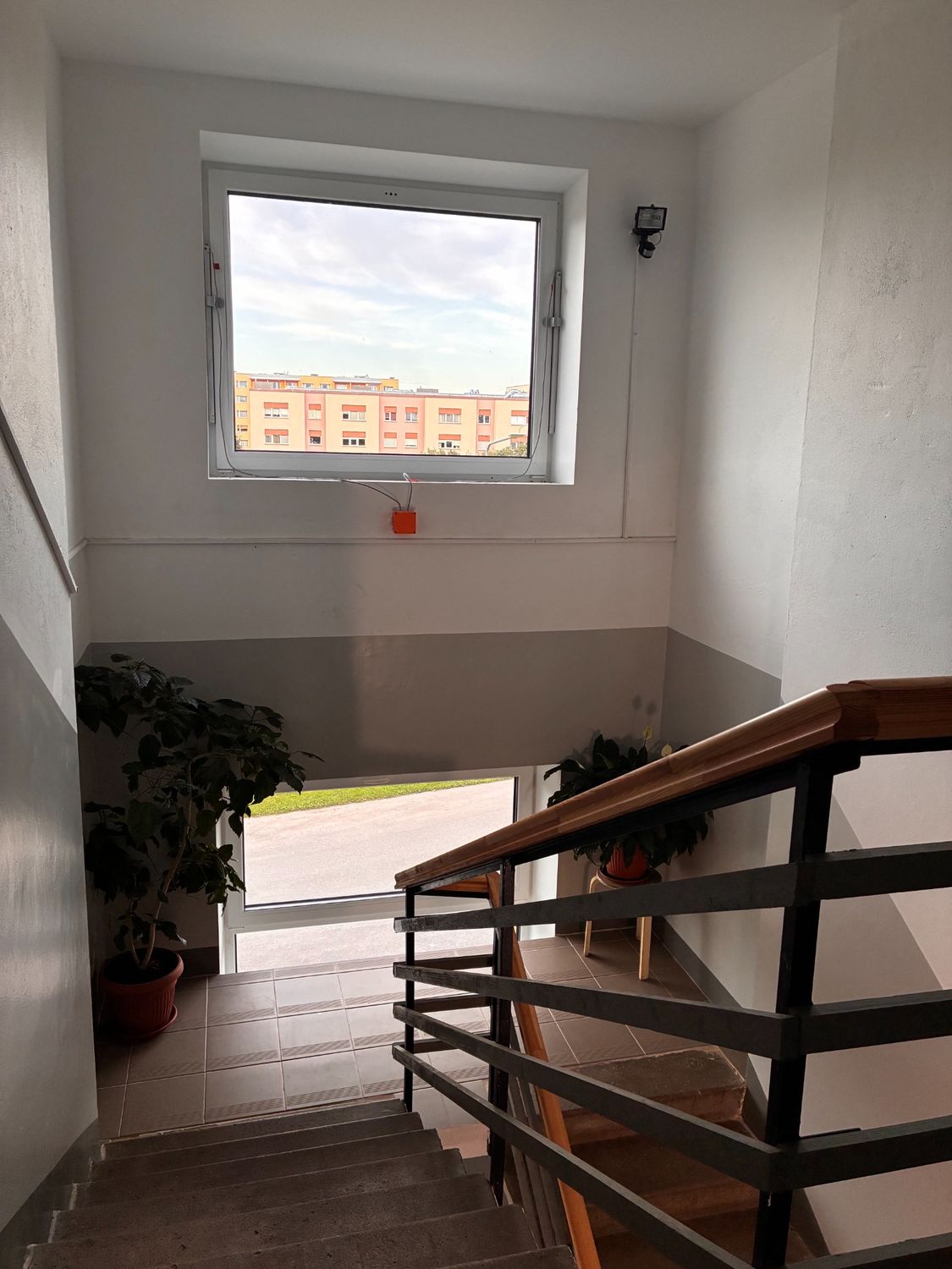 Grey stairwell with clean wall finish and natural light.