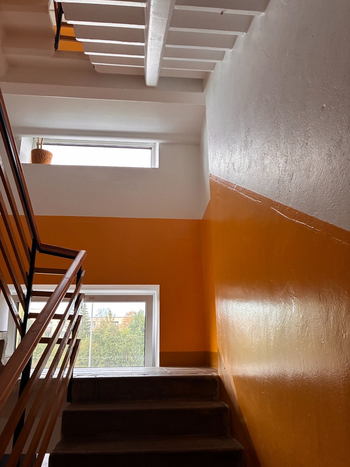 Orange hall with completed wall and ceiling finish.