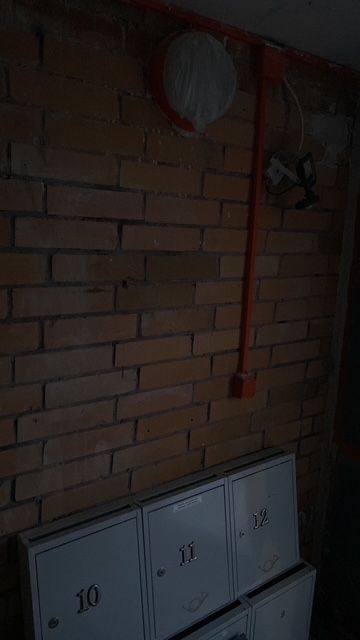 Old brick wall and electrical cabinet area.