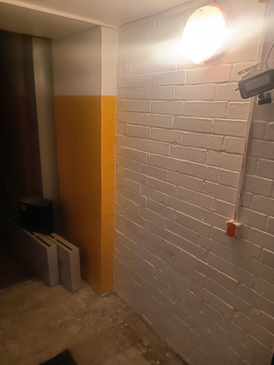Wall painting and finishing in progress.