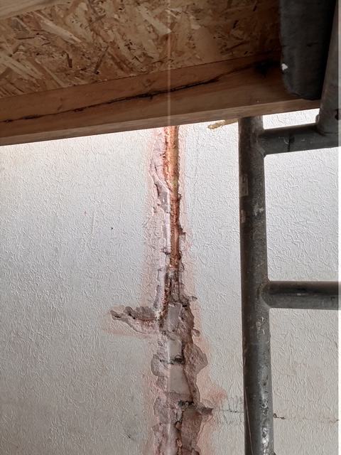 Wall crack exposed before repair.