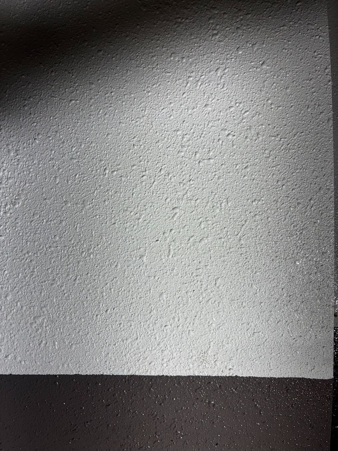 Close-up of orange peel decorative sprayed plaster texture.