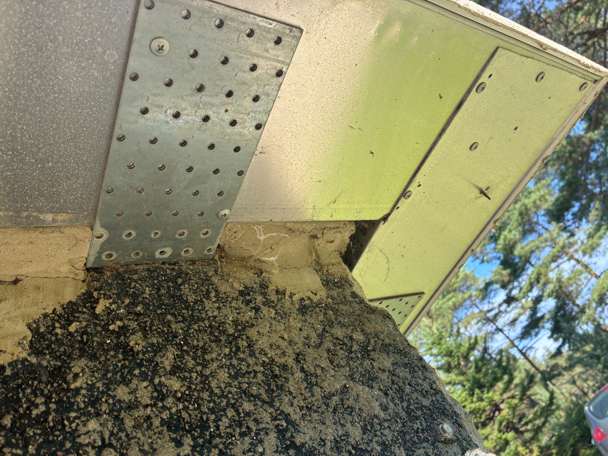 Close-up of perforated metal plates at the eaves connection