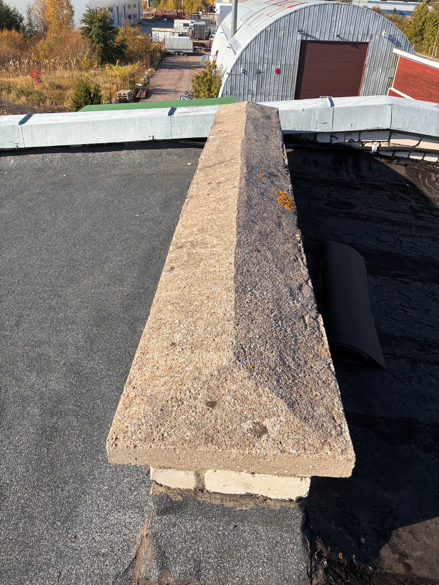 Before renovation: aged roof and central curb