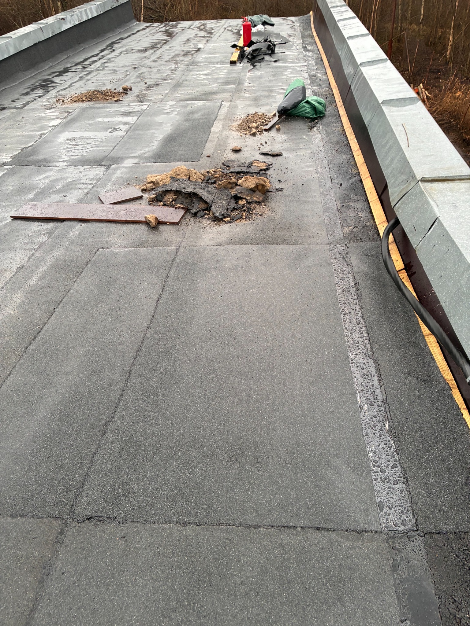 Roof renovation in progress with new SBS membrane being installed
